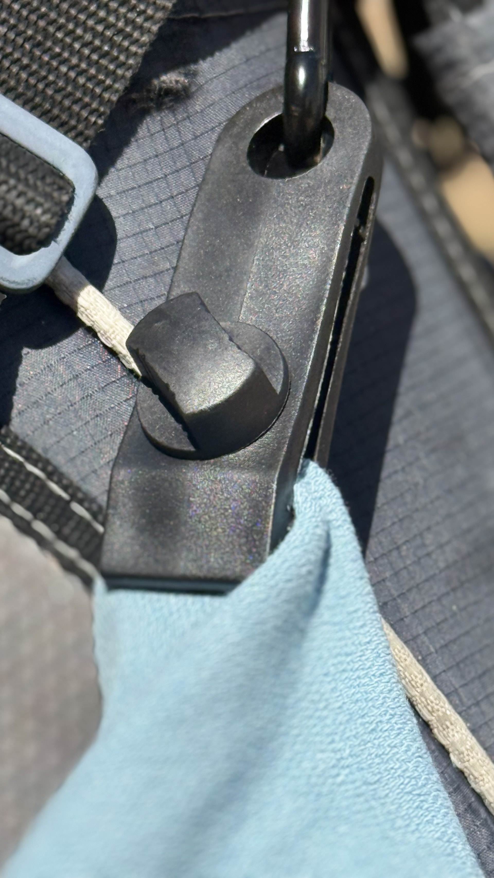 Close-up of the heavy-duty bag clip holding the light blue Jook Towel on a bag